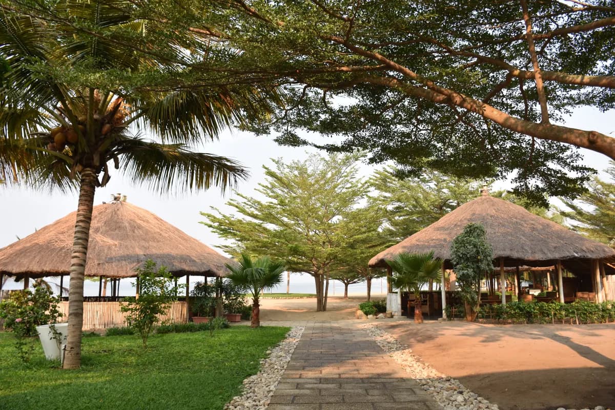 Lakeside gardens and thatched pavilions at Hotel Club du Lac Tanganyika
